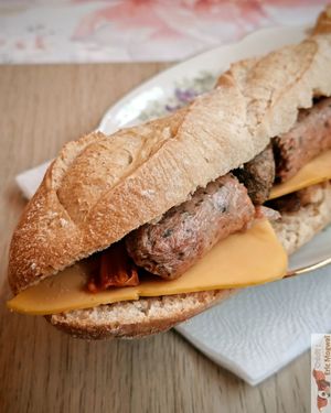  A “Ruth Landry” cheese and vegan sausage sandwich with fresh bread.Baguette, shallot confit with maple syrup, vegan cheese, carrots with maple syrup, vegan protein, and barbec at MAGIC COFFEE SHOP in Nogent-sur-marne