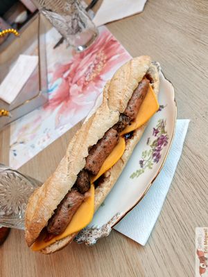  A “Ruth Landry” cheese and vegan sausage sandwich with fresh bread.
Baguette, shallot confit with maple syrup, vegan cheese, carrots with maple syrup, vegan protein, and barb at MAGIC COFFEE SHOP in Nogent-sur-marne