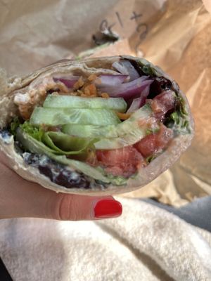 Veggie hummus wrap with pickled carrots added   at Purple Tomato Farmers Market in Lincoln