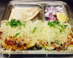 Bread bun topped with onion and capsicum paste...garnished with cheese. at Relish India in Surry Hills