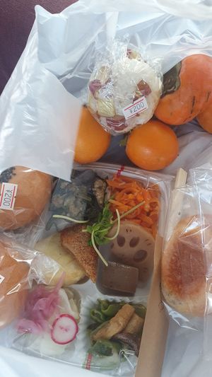Box with side dishes, rice balls, an Pan and organic kaki at VEGE & DELI - らでぃっしゅ in Takamatsu