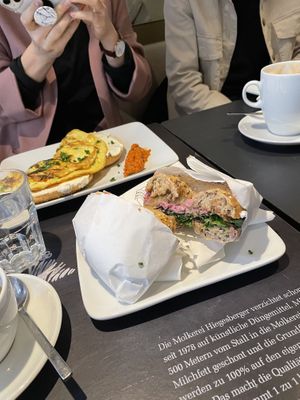 vegan bagel with red-beet-hummus, pickles, onions, ruccola and sweet mustard; in the background vegetarian bagel omelette   at Blueorange Coffee and Bagel - Margaretenstrasse in Vienna
