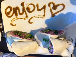 Hummus wrap with a cute enjoy message!  at Blueorange Coffee and Bagel - Margaretenstrasse in Vienna