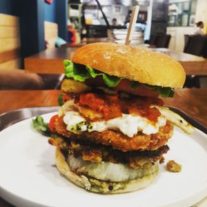 Premium triple burger (basil pesto + tomato sauce + tartar sauce + tofu patty + homemade vegan patty + vegetables) at Coexistence Vegan Cafe in Seoul