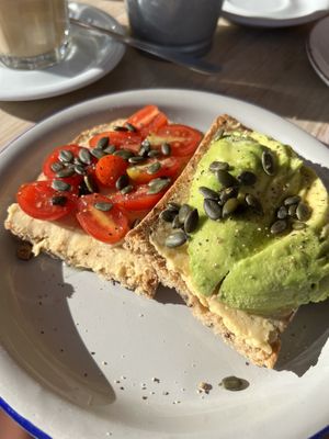 Traditional Hummus Toast with Avocado and Cherry Tomato’s   at Oroma Coffee & Brunch in Cataluña