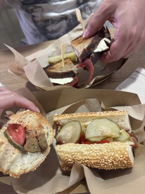 pastrami sandwich with sourdough bread and country sausage  at Sacred Garden Plant Based Deli in Rhodes