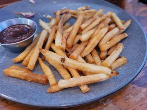 Stale, overcooked, store-bought (frozen, then cooked) french fries, served as "beer-battered fries". They were gross! at True North in Coburg