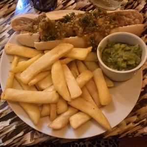 Battered hot dog with peas & curry sauce at Big Scoffs Diner in Leeds
