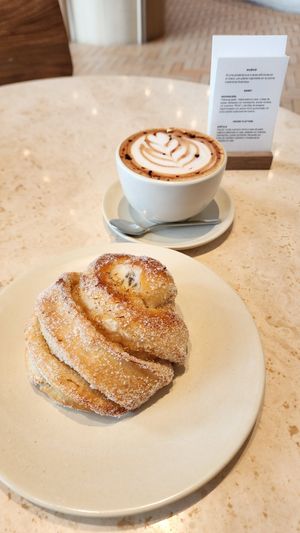 Lavander Bun with Latte at Krume Bäcker in Provincia De Panamá