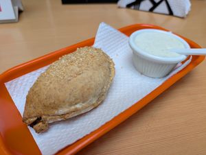 Baked Hawaiian empanada and delicious garlic sauce! at De Nobles in Bogota