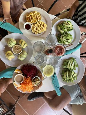 Family breakfast: fresh spring rolls, arugula beet salad w/ added lentils, hummus & pesto sandwich (no beets sub avo), banana nut sandwich, cucumber mint juice, watermelon basil at Juice Bar at the Harmony Hotel in Nosara
