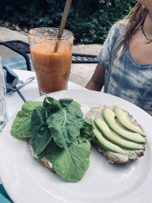 Their very seedy and delicious homemade bread with pesto, hummus, arugula, and avocado and the spicy tomato savory smoothie😍 at Harmony Hotel Restaurant in Nosara