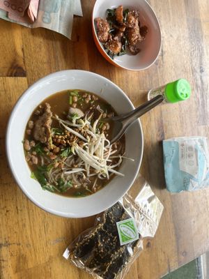 So good! Spicy Tom yum! Plug seaweed snacks and crispy tofu for 60 baht.   at Sangwiroon Vegetarian in Chiang Mai