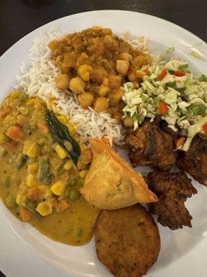 Buffet selections-chickpea masala, spicy salad, veg curry, pakoras and samosas.  at Radhe Pure Veg & Vegan in Oklahoma City