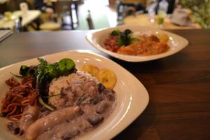 Stewed peas with spelt flour dumplings, wild rice, a side of fried plantain and three raw salads - Apple Beetroot & Carrot, Green power and Cauliflower rice. at The Calabash of Culture in South East London