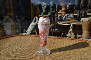Vegan Knickerbocker Glory topped with whipped cream at The Calabash of Culture in South East London
