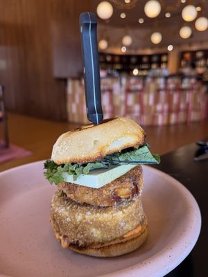 fried tofu patty, mash brown, calabrian chili aioli, kale, and beer cheese on an english muffin  at Adelleda in Portland