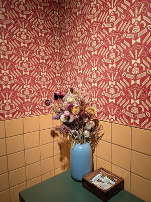 pasta wallpaper and free tampons in bathroom at Adelleda in Portland