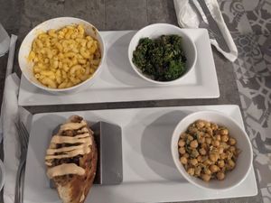 Mac and cheese with kale side. Crab cake pita with chickpea side. at The Vegetable Hunter Cafe and Boutique Brewery in Harrisburg