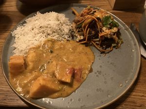 Coconut mango curry; and salads with mango and tofu  at Moksha in Kaunas