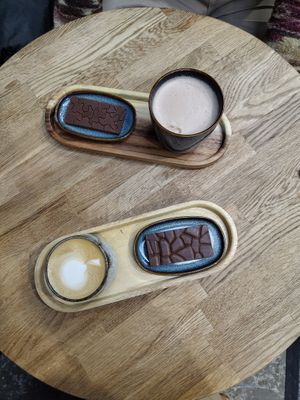 Cappuccino and maca with a piece of selfmade chocolate  at As Good As It Gets in Tilburg