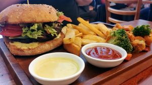 Bhakti burger with chips and salad at Radhey Chai Bar in Fitzroy