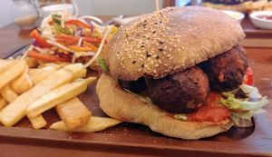 Kofta burger with chips and salad  at Radhey Chai Bar in Fitzroy