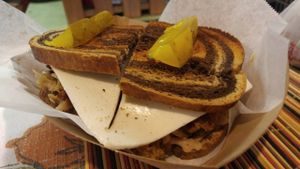 RACHEL ON RYE
6-ounces of Vegan Pastrami and Cheese topped with a mix of traditional German and Latin Sauerkraut stacked on Jewish Rye, dressed in our signature Mustard and served with a Dill Pickle at Atlas Meat-Free Delicatessen in Miami