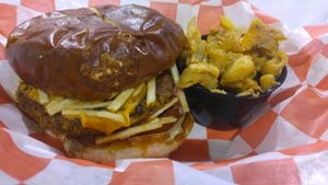 cheese burger with side mac and cheese at Atlas Meat-Free Delicatessen in Miami