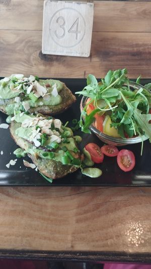 Cudaki - Potatoes stuffed with cashew nuts, tofu, chives, and almonds, baked with spinach and nut cheese sauce, and smoked tempeh + zucchini, carrot, marinated with fennel, served  at Vege Miasto in Warsaw