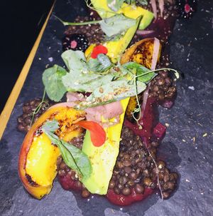 Grilled Peach Salad w/ Black Lentils, Avocado, Greens and Blueberry Chipotle Salsa at Mesa Verde in Santa Barbara
