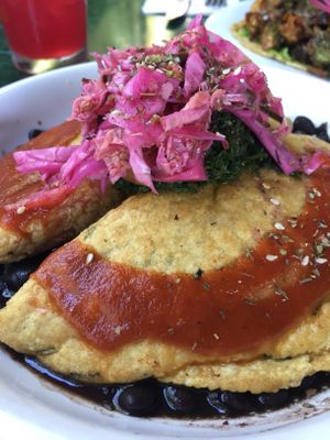 Empanada on a bed black beans. Full of flavor. at Mesa Verde in Santa Barbara