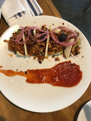 Picadillo Tacos - seasoned jackfruit and tempeh served in lettuce wraps with thin apple slices and blackberries - savory and sweet!  at Mesa Verde in Santa Barbara