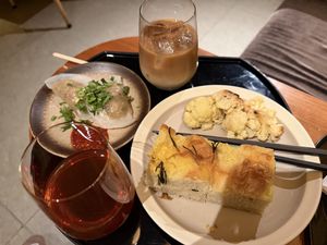Steamed vegetable dumplings, focaccia and grilled cauliflower with iced tea and oat milk latte   at HKG - Cathay Pacific The Pier Business Lounge - 國泰航空 「玉衡堂」商務貴賓室 in New Territories