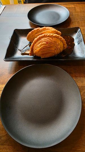 The Vegan Curry Puffs and our plates.  at CoCoCurry - Thai Curry Cafe in San Diego