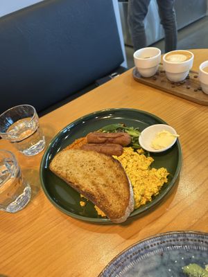 Tofu scramble, toast, and vegan sausage.   at Avodi Vegetarian & Cafe in Auckland