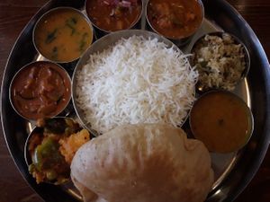Rice with 8 different vegan curries and puri at Tharavadu in Leeds
