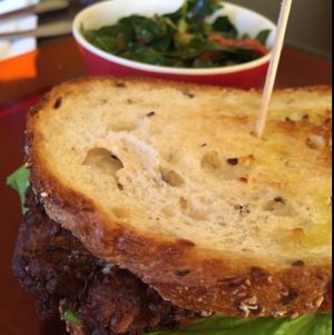 Vegan crabcake sandwich with collard salad. The salad was very good! at E'lure Bistro in Conyers