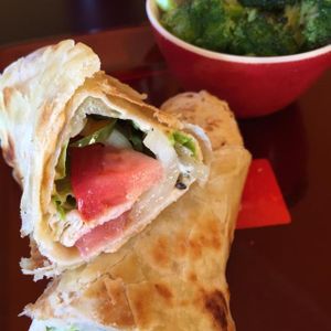 Grilled veggie wrap with homemade hummus and a side of grilled brocolli on the side at E'lure Bistro in Conyers