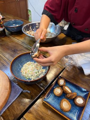 Stuffing mushrooms with tofu filling at Rose Kitchen in Hà Nội