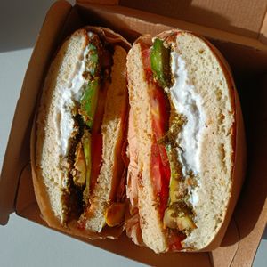 Vegan Baladi kaak bagel with za'atar, labneh, tomato, cucumber, olives :)) at 1947 in Boronia