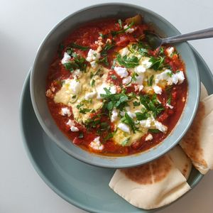 Shik shak shuka with scrambled tofu and rich savoury tomatoes, feta, pita bread at 1947 in Boronia