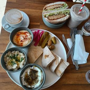 dips plate (hommus, coconut labneh, baba ganoush), vegan schnitty sandwich, choc banana smoothie, almond capp at 1947 in Boronia