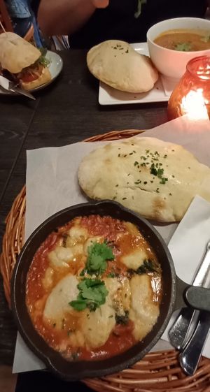 Vegan spinach shakshuka with lentil soup and hummus sandwich in the background at Kafe Spesial in Bergen