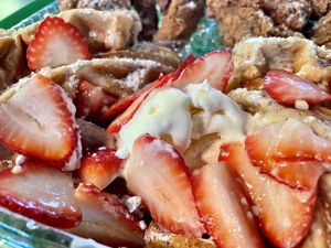 Closeup of the waffle smothered in vegan butter & sliced strawberries    at Katelyn’s Vegan Soul Cafe (2nd location) in Daytona Beach