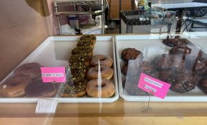 Display case with clearly labeled vegan options  at Sweet Donuts in Olympia