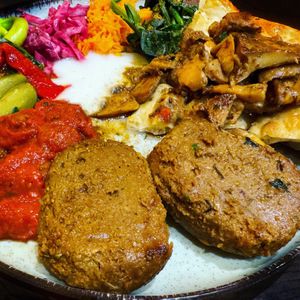 Kofte Plate with tons of fresh veggie salads and homemade yogurt!   at Vegan Community Kitchen in Istanbul