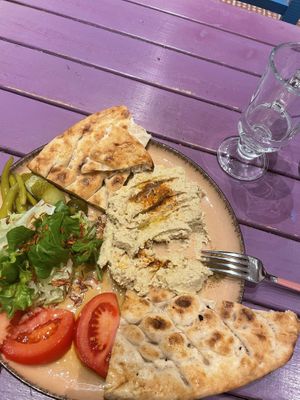 Hummus served with bread and salad   at Vegan Community Kitchen in Istanbul