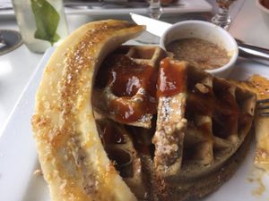 Sunday Brunch option: waffles with Caramelized bananas, bourbon-peach sauce, and smoked almond butter at Small Batch in St Louis