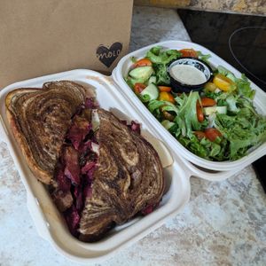 Seitan Beet Reuben - brined seitan, roasted beets, cashew swizz, sauerkraut, Russian dressing, & fried pickles on grilled marble rye, side salad w/ tahini dressing at Modern Love in Omaha